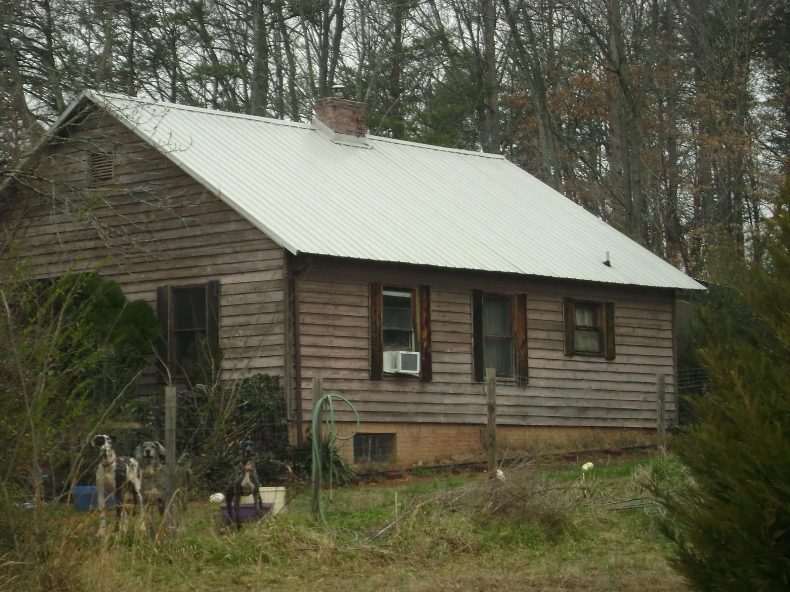 White metal roof on an old wood sided farmhouse, from a Metal Roof Installation job in Jewell